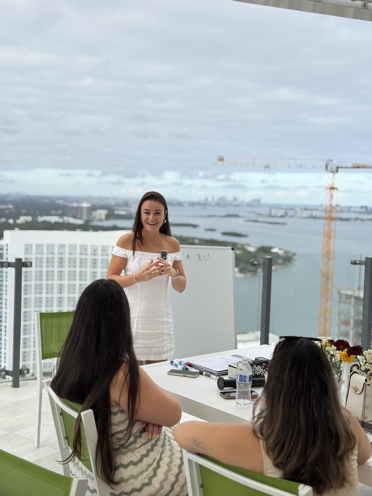 Presenting to a seated group on a Miami rooftop terrace