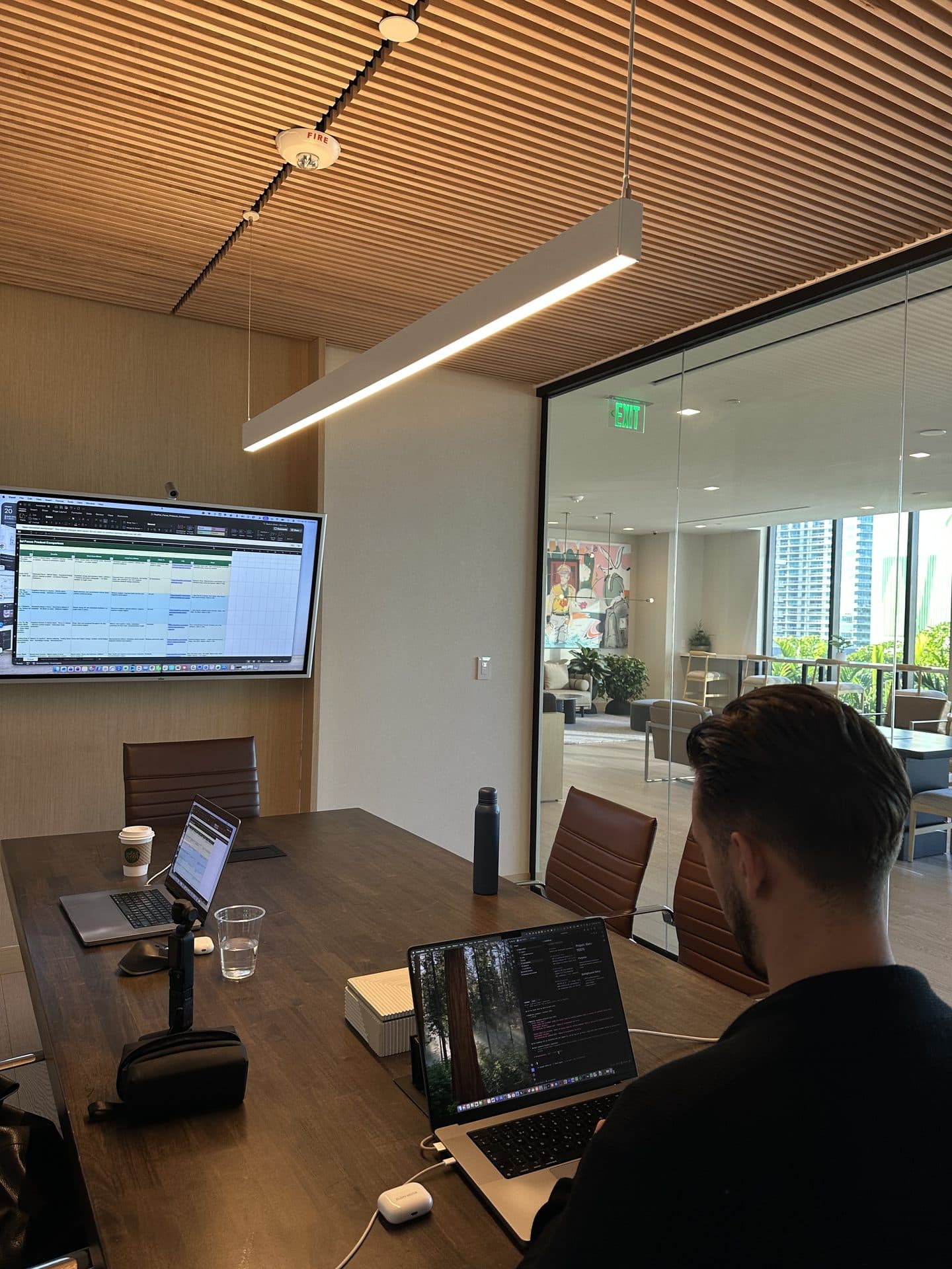An MYA team member at a laptop in the conference room